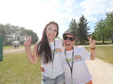 Volunteers Corinne Gusnoski and Laura Lazarenko give peace signs as they welcome Folkies to the 46th annual Winnipeg Folk Festival at Birds Hill Provincial Park, north east of Winnipeg, Man., on Thursday, July 11, 2019. The annual Winnipeg Folk Festival runs July 11 to 14, 2019.