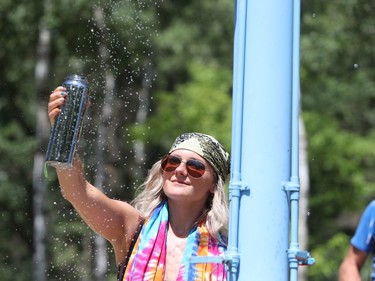 Winnipeg resident Ashley Jolicoeur fills up her reusable water bottle from an outdoor shower while attending the 46th annual Winnipeg Folk Festival at Birds Hill Provincial Park, north east of Winnipeg, Man., on Saturday, July 13, 2019. This year's Folk Festival runs July 11 to 14, 2019.