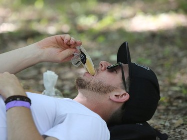 Winnipegger Michael Gorric cools off while enjoying a popsicle as he attends the 46th annual Winnipeg Folk Festival at Birds Hill Provincial Park, north east of Winnipeg, Man., on Friday, July 12, 2019. This year's Folk Festival runs July 11 to 14, 2019.