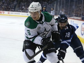 Dallas Stars Julius Honka (left) is pursued by Winnipeg Jets forward Bryan Little in Winnipeg on Sun., March 18, 2018. Kevin King/Winnipeg Sun/Postmedia Network