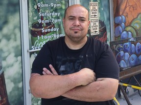Ramsey Zeid stands in front of the Food Fare location on Maryland Street in Winnipeg on Tuesday. The owners of a chain of small, independent Winnipeg grocery stores opened the doors of the five Food Fare locations on Canada Day Monday, defying a law they say is unfair and detrimental to their family-owned business.