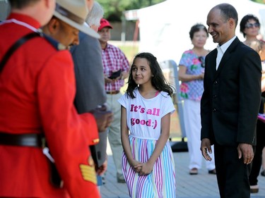 Akriti Bhattarai (centre) meets with dignitaries and RCMP officers after her and father Amber became Canadian citizens during a special ceremony at Assiniboine Park in Winnipeg on Mon., July 1, 2019. Kevin King/Winnipeg Sun/Postmedia Network