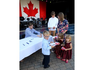 Daria Koval (top right), along with son Mark, 6, and twin daughters Ameila and Alyssa, 3, and Artem Riazanov (top left) sign papers to become Canadian citizens during a special ceremony at Assiniboine Park in Winnipeg on Mon., July 1, 2019. The Kovals came to Winnipeg from Russia. Kevin King/Winnipeg Sun/Postmedia Network