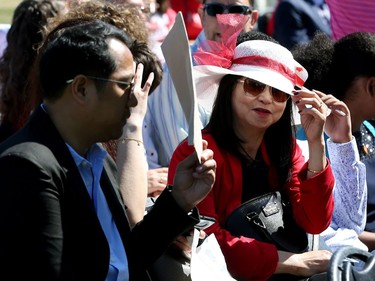 People attending a special citizenship ceremony at Assiniboine Park in Winnipeg try to block the sun on Mon., July 1, 2019. Kevin King/Winnipeg Sun/Postmedia Network