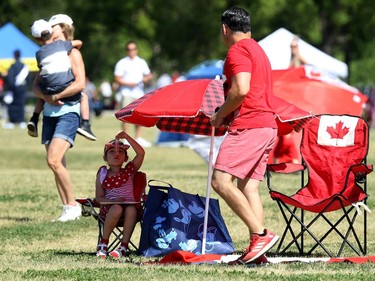 Sofia Figueroa, 6, downs a freezie while her father Alfonso sets up their spot at Assiniboine Park in Winnipeg during a special citizenship ceremony on Mon., July 1, 2019. Kevin King/Winnipeg Sun/Postmedia Network