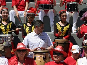 Mayor Brian Bowman (centre) helps out during a Guinness World Record attempt for largest group drum roll in multiple venues at the Chinatown Gardens on King Street in Winnipeg on Monday. Winnipeg was one of 11 communities coming together to vie for the record.