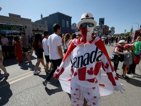 Tom Graban walks the street with pride at the Canada Day Street Festival on Osborne Street last year. Canada Day celebrations at both The Forks and Osborne Village have been cancelled due to the pandemic, though The Forks will be taking to their Facebook and Youtube channels with Canada Day Virtual starting at 2 p.m.