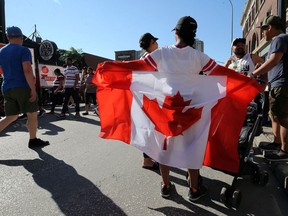 A flag flies at the Canada Day Street Festival on Osborne Street in Winnipeg on Mon., July 1, 2019.