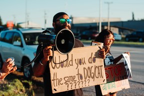 The group of about 15 activists from Manitoba Animal Save protest the Manitoba Stampede and Exhibition in Morris, Man., on Friday. The group waved signs calling for stampedes to be banned in Manitoba, claiming the events are outdated and cause unnecessary violence against the animals.