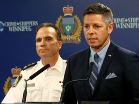 Mayor Brian Bowman (right) speaks with Chief Danny Smyth looking on during a press conference to discuss the annual statistical report at Winnipeg police headquarters on Mon., July 22, 2019. Kevin King/Winnipeg Sun/Postmedia Network