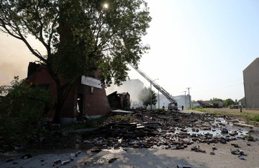 Firefighters work to extinguish the remnants of a warehouse fire on Jarvis Avenue on Mon., July 22, 2019. Kevin King/Winnipeg Sun/Postmedia Network