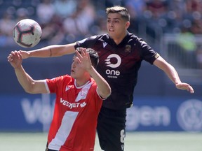 Valour FC's Diego Gutierrez behind Calvary FC player Carlos Patino in game action, in Winnipeg on Saturday, July 27.