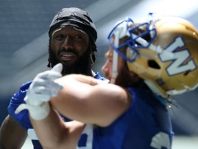 Defensive back Brandon Alexander (left) speaks with safety Jeff Hecht during Winnipeg Blue Bombers practice on Tuesday.