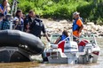 RCMP officers do a routine stop of a boat along the Red River.