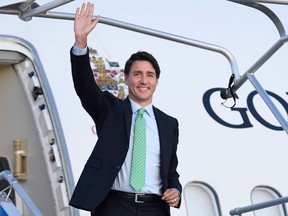 Canadian Prime Minister Justin Trudeau waves as he arrives in Biarritz, south-west France on August 23, 2019, on the eve of the annual G7 Summit.