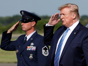 U.S. President Donald Trump salutes as he arrives at Morristown municipal airport for a weekend at the Trump National Golf Club in Bedminster, N.J., August 2, 2019. (REUTERS/Yuri Gripas)