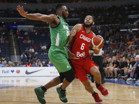 Canada's Cory Joseph (6) works his way around Nigeria's Josh Okogie (20) on his way to the net during the first half of their exhibition game in Winnipeg on, Friday. THE CANADIAN PRESS/John Woods