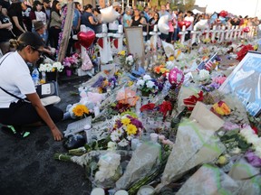EL PASO, TEXAS - AUGUST 06: People gather at a makeshift memorial honoring victims outside Walmart, near the scene of a mass shooting which left at least 22 people dead, on August 6, 2019 in El Paso, Texas.  A 21-year-old white male suspect remains in custody in El Paso, which sits along the U.S.-Mexico border. President Donald Trump plans to visit the city August 7.