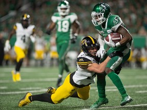 Saskatchewan Roughriders receiver Kyran Moore, right, made some big plays late in the fourth quarter during Thursday's 24-19 victory over the visiting Hamilton Tiger-Cats.