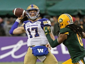 Winnipeg Blue Bombers quarterback Chris Strevelar (left) is chased down by by Edmonton Eskimo Don Unamba during Canadian Football League game action in Edmonton on Friday August 23, 2019. (PHOTO BY LARRY WONG/POSTMEDIA)