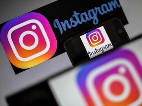 In this file photo taken on May 2, 2019 logos of US social network Instagram are displayed on a screen of a smartphone in Nantes, western France. - Instagram on August 15, 2019 added a way for users to easily report deceptive posts at the photo and video-oriented social network owned by Facebook.