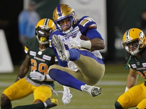 Winnipeg Blue Bombers Andrew Harris makes a leaping reception during Canadian Football League game action against the Edmonton Eskimos in Edmonton, last Friday.