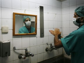 A Palestinian doctor washes his hands prior to a joint operation with U.S. doctors to help Palestinian boy Abdullah Shawwa, 4, in the Shifa hospital in Gaza City, Tuesday, Jan. 27, 2009.