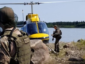 RCMP officers preapare to continue search forB.C. murder suspects Kam McLeod, 19, and Bryer Schmegelsky, 18, near Gillam last week.