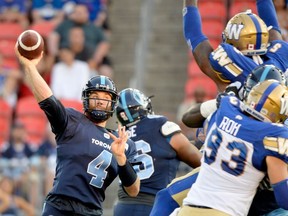 Argonauts quarterback McLeod Bethel-Thompson makes the pass under pressure during first-half action against the Winnipeg Blue Bombers on Thursday night in Toronto. The Argos rallied for their first win of the season.  (NATHAN DENETTE/THE CANADIAN PRESS)