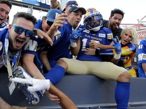 Winnipeg Blue Bombers receiver Nic Demski celebrates his touchdown catch against the B.C. Lions during CFL action with fans in the stands in Winnipeg on Thursday night. (KEVIN KING/WINNIPEG SUN)
