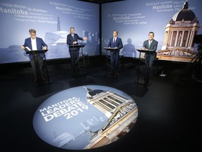 Liberal Party of Manitoba leader Dougald Lamont, left to right, Progressive Conservative leader and Manitoba Premier Brian Pallister, NDP leader Wab Kinew and Green Party of Manitoba leader James Beddome prepare for a leaders' debate at CBC in Winnipeg, Wednesday, August 28, 2019. Manitobans go to the polls Sept. 10.