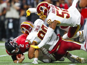 Quarterback Matt Ryan of the Atlanta Falcons is sacked by Montez Sweat and Ryan Anderson of the Washington Redskins during a NFL preseason game at Mercedes-Benz Stadium on August 22, 2019 in Atlanta. (Todd Kirkland/Getty Images)