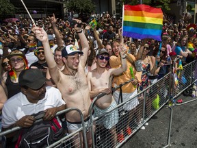 Spectators take in the Pride parade along Yonge St. in downtown Toronto, Ont. on Sunday June 23, 2019.