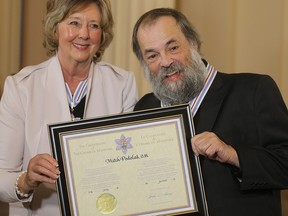 Lt. Gov. Janice Filmon (left) presents the Order of Manitoba to Mitch Podolak on Thursday July 9, 2015. Podolak died Sunday at the age of 71 after battling serious health issues for several years.