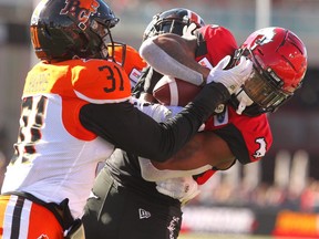 Stamps Receiver Markeith Ambles gets tied up with Lions Linebacker Maleki Harris and DB Garry Peters during the 1st half of action as Calgary Stampeders play host to the BC Lions at McMahon Stadium during week 3 of CFL action. Saturday, June 29, 2019. Brendan Miller/Postmedia