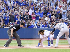 Blue Jays third baseman Vladimir Guerrero Jr. slides into third base ahead of the tag from New York Yankees third baseman Gio Urshela (29) during the seventh inning at the Rogers Centre on Saturday. (Nick Turchiaro/USA TODAY Sports)