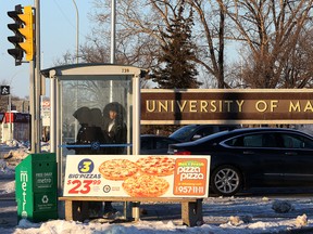 Transit riders await their bus in a shelter on Pembina Highway at Chancellor Matheson Road near the University of Manitoba in Winnipeg on Saturday, Dec. 17, 2016. In cold Winnipeg winters, spending hours getting where you need to go is not what Winnipeggers should have to deal with, according to the head of the Canadian Urban Transit Association.