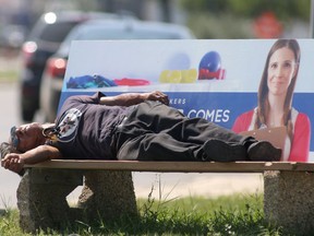 A person resting on a bench, beside Pembina Highway, in the heat of the day, in Winnipeg.
Thursday, August 01/2019 Winnipeg Sun/Chris Procaylo/stf