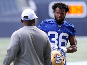 Newcomer Mercy Maston (right) speaks with defensive co-ordinator Richie Hall at Winnipeg Blue Bombers practice at IG Field on Monday.