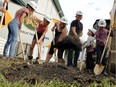 Travis Wilson and Kimberlee Chester (centre), along with children Zoe, Khloee, Cadon, and Gavin (from left) turn sod at a Habitat for Humanity Manitoba ground-breaking ceremony on Stella Avenue in Winnipeg on Tuesday.