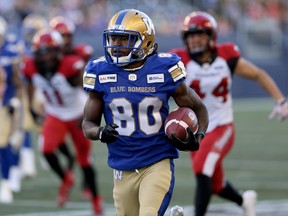 Winnipeg Blue Bombers returner Janarion Grant returns a first-quarter punt for a touchdown during CFL action against the Calgary Stampeders in Winnipeg on Thursday, Aug. 8.