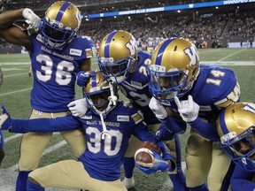 Winnipeg Blue Bombers defensive back Winston Rose (30) celebrates with teammates Mercy Maston, Anthony Gaitor, and Marcus Sayles (from left) after a late interception against the Calgary Stampeders during CFL action in Winnipeg on Thurs., Aug. 8, 2019. Kevin King/Winnipeg Sun/Postmedia Network