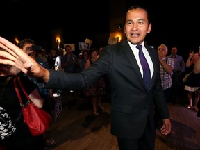 NDP leader Wab Kinew waves to supporters upon his arrival at his nomination party for the Fort Rouge riding at the Park Theatre in Winnipeg on Sunday.