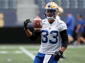 Running back Andrew Harris flips the ball after a catch during Winnipeg Blue Bombers practice at IG Field on Monday.