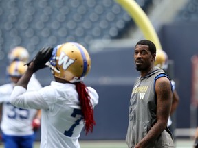 injured receiver Darvin Adams (right) speaks with Lucky Whitehead during Winnipeg Blue Bombers practice at IG Field on Monday. Whitehead returned a kickoff for a touchdown earlier this season.