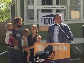 Manitoba NDP Leader Wab Kinew announces plan to offer a $1,000 reduction on the land-transfer tax for first-time homebuyers and people with disabilities at a media event in Winnipeg on Friday, accompanied by prospective first-time home-buyers Ben and Carly Cressman along with daughters Hannah (far left) and Stella (third from left).