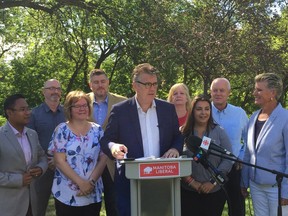 Manitoba Liberal Leader Dougald Lamont (centre) announces the Liberals plan to increase the minimum wage and develop programs to fight poverty if his party were to win the Sept. 10 provincial election at a press conference on Tuesday, Aug. 20, 2019 at Bonnycastle Park in Winnipeg. Lamont was joined by Manitoba Liberal candidates. GLEN DAWKINS/Winnipeg Sun/Postmedia Network