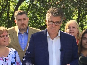 Manitoba Liberal candidate for St. Vital Jeffrey Anderson (second from left) listens as Manitoba Liberal Leader Dougald Lamont (centre) announces the Liberals plan to increase the minimum wage and develop programs to fight poverty if his party were to win the Sept. 10 provincial election at a press conference on Tuesday, Aug. 20, 2019 at Bonnycastle Park in Winnipeg. Anderson was canvassing with two supporters in a Winnipeg apartment building on Monday, Aug.19, 2019, when he said he was attacked. Anderson says a man started berating one of his supporters about being in the building, at which point Anderson intervened and the man started making threats and allegedly reached into his pocket for something. The Winnipeg police were called to the scene and no one was injured and no charges have been laid. GLEN DAWKINS/Winnipeg Sun/Postmedia Network