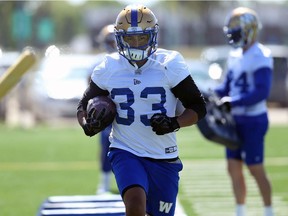 Running back Andrew Harris carries the ball during Winnipeg Blue Bombers practice on the University of Manitoba campus in Winnipeg on Monday.