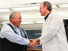 (Left to right) Manitoba Metis Federation President David Chartrand shakes hands with Director of the Youth BIOlab at the St. Boniface Hospital Stephen Jones at the presentation of a cheque for $75,000 on Tuesday by the Manitoba Metis Federation to the St. Boniface Hospital Foundation for the RBC Youth BIOlab Jeunesse. The MMF later doubled their donation.